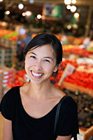 Portrait of woman smiling in market - Mary Grace Long