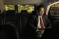 Mature man sitting in car working on laptop - Alex Mares-Manton
