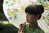 Young woman wearing a Chinese traditional dress and holding an umbrella - Alex Mares-Manton