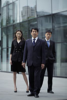Business people standing in front of a building - Alex Mares-Manton