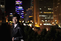 Young man walking on the streets at night, Beijing, China - Alex Mares-Manton