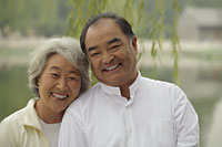 Older couple smiling together outdoors - Alex Mares-Manton