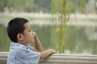 Profile of young boy looking at a lake. - Alex Mares-Manton