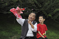Grandfather and grandson playing with a kite - Alex Mares-Manton