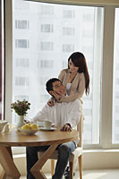 Young couple smiling at each other in their condo - Alex Mares-Manton