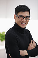Head shot of young man wearing glasses and smiling - Alex Mares-Manton