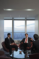 Three businessmen talking in office - Alex Mares-Manton