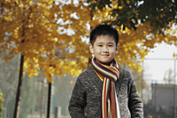 Young boy wearing sweater and scarf outdoors - Alex Mares-Manton