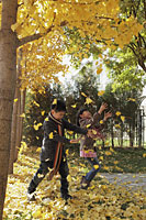 Young boy and girl playing in the Autumn leaves - Alex Mares-Manton