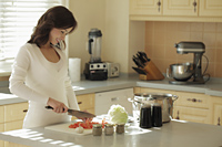 Young woman preparing food in her kitchen - Alex Mares-Manton