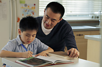 Father helping son with his homework - Alex Mares-Manton