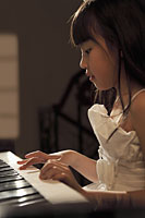 Profile of young girl playing piano - Alex Mares-Manton