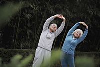 Older man and woman stretching together outdoors - Alex Mares-Manton