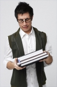 Nerdy man with books - Asia Images Group