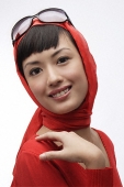 Portrait of woman wearing red sweater, scarf and sunglasses - Asia Images Group