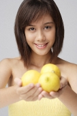 Young woman holding lemons - Asia Images Group