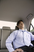 Businessman in backseat of car - Asia Images Group