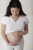 Pregnant woman holding her stomach - Asia Images Group