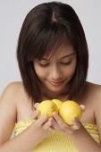 Young woman smelling lemons - Asia Images Group