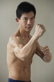 Man in martial arts pose - Asia Images Group