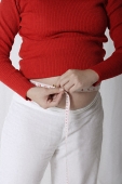 Pregnant woman measuring stomach - Asia Images Group