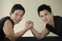 Two men ready to arm wrestle - Asia Images Group