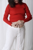 Pregnant woman measuring stomach - Asia Images Group