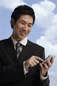 businessman using hand held device - Asia Images Group