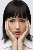 Portrait of woman with hands on face - Asia Images Group