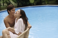 Young couple enjoying each other by the pool - Asia Images Group