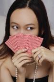 Young woman holding game cards - Asia Images Group