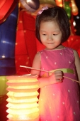 Little girl holding Chinese lantern - Asia Images Group