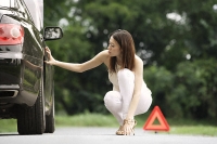 Woman inspecting car - Asia Images Group