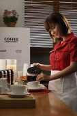 Waitress in diner pouring coffee - Asia Images Group