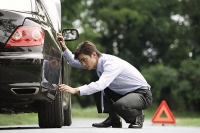 Man inspecting car - Asia Images Group