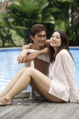 Young couple enjoying each other by the pool - Asia Images Group