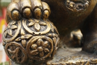Close up of statue of lion's paw on orb - Asia Images Group