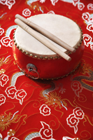 Still life of Chinese drum on Chinese silk fabric - Asia Images Group