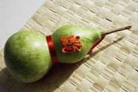 Still life of bottle gourd on weaved mat - Asia Images Group