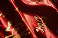 Detail of red Chinese silk fabric - Asia Images Group