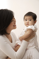 Woman holding baby girl - Asia Images Group