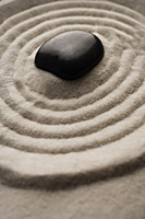 closeup of zen garden pebble detail on raked sand - Asia Images Group