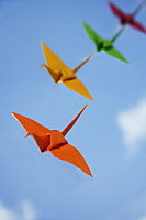 multiple paper cranes against sky backdrop - Asia Images Group
