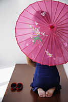 young Chinese woman in blue cheongsam holding pink umbrella - Asia Images Group