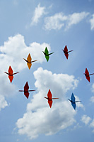 multiple paper cranes against sky backdrop - Asia Images Group