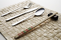 fork, knife, spoon and chopstick dinner setting - Asia Images Group