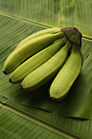 bunch of bananas on banana leaf - Asia Images Group
