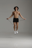 man working out with jump rope - Asia Images Group