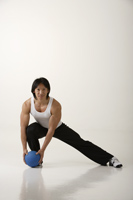Man working out with medicine ball - Asia Images Group