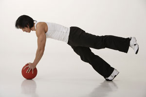 Chinese man working with medicine ball - Asia Images Group